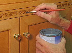 Closeup of painter apply vanish to inlaid trim