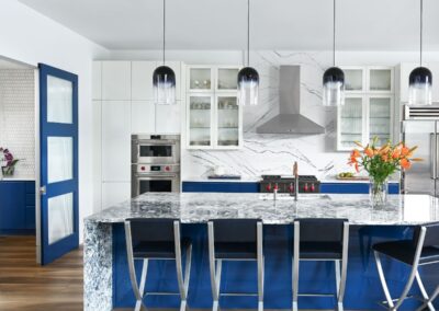 A kitchen project in Lake Conroe with white and royal blue Euro style cabinets with no handles